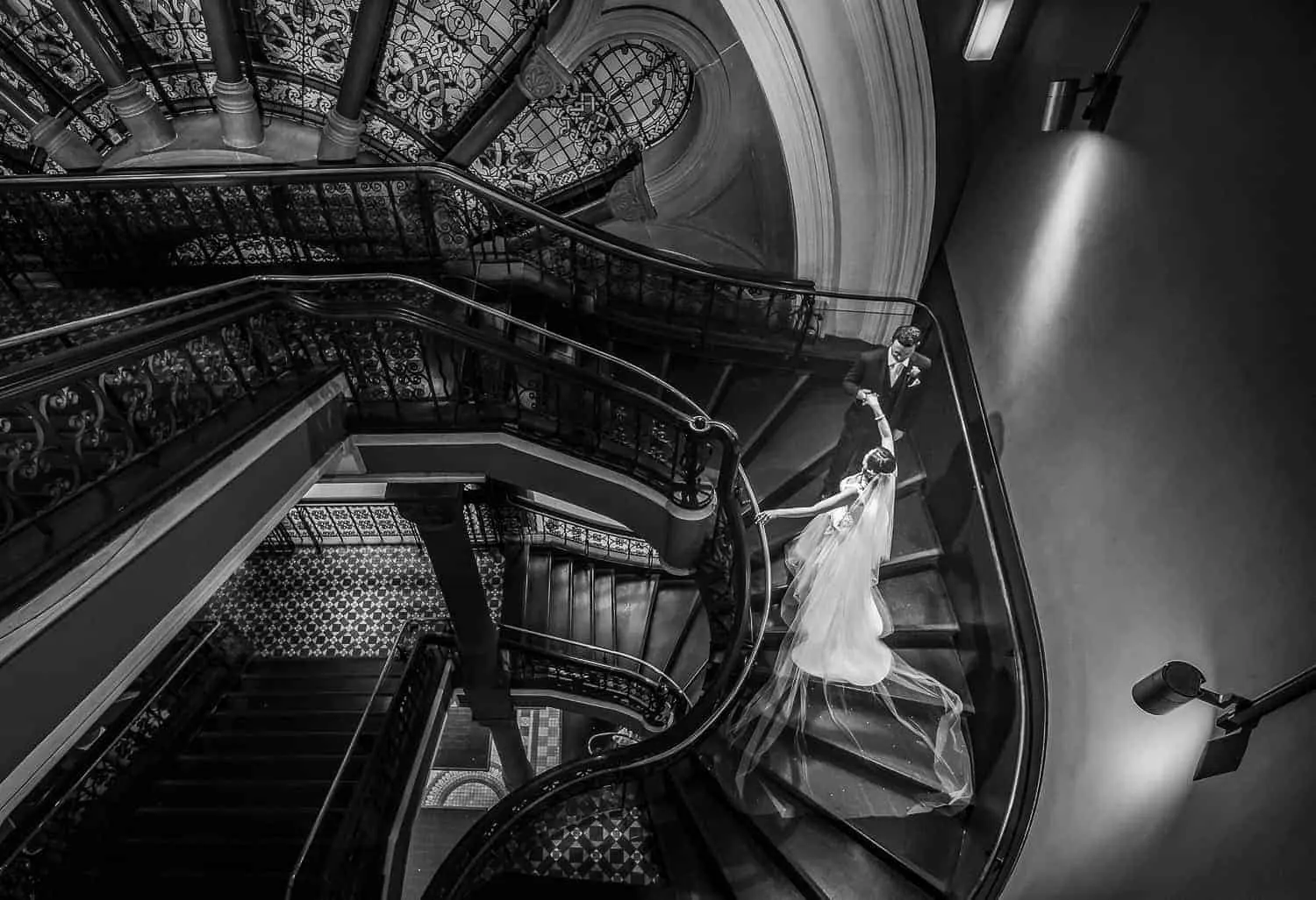Black and white wedding portrait on a grand staircase