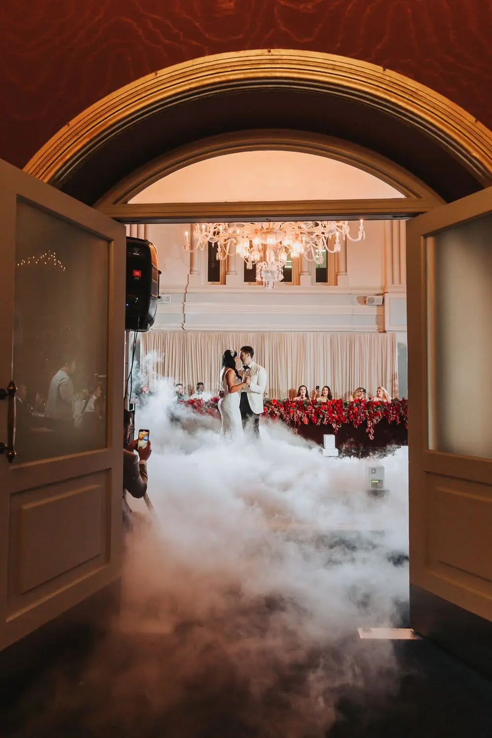 Ivana and Ivan sharing a dance through low fog in The Tea Room, QVB beneath a chandelier